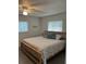 Spacious bedroom with king-size bed, ceiling fan, and tile floor at 935 Rhodes Ave, Sarasota, FL 34237