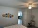 Bright bedroom with a view of the living room and unique wall art at 935 Rhodes Ave, Sarasota, FL 34237