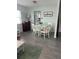 Small dining area with white table and chairs, view into kitchen at 935 Rhodes Ave, Sarasota, FL 34237