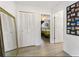 Bright hallway with mirror, double doors and view of bedroom at 935 Rhodes Ave, Sarasota, FL 34237