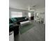 Spacious living room with sectional sofa, dining area, and tile floors at 935 Rhodes Ave, Sarasota, FL 34237
