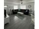 Bright living room featuring a large sectional sofa and tile floors at 935 Rhodes Ave, Sarasota, FL 34237