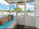 Relaxing screened porch with built-in seating and access to backyard at 935 Rhodes Ave, Sarasota, FL 34237