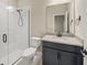Modern bathroom with dark vanity and a shower at 9511 Tequila Sunrise Dr, Sarasota, FL 34241