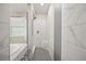 Spa-like shower with gray hexagon tile and built-in seat at 9511 Tequila Sunrise Dr, Sarasota, FL 34241