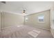Well-lit bedroom, carpeted floor, ceiling fan, and windows at 9511 Tequila Sunrise Dr, Sarasota, FL 34241