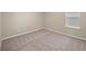 Bright bedroom featuring carpeted floor and window at 9511 Tequila Sunrise Dr, Sarasota, FL 34241