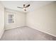 Bedroom with ceiling fan, carpet, and window at 9511 Tequila Sunrise Dr, Sarasota, FL 34241