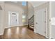 Bright entryway with hardwood floors, staircase, and high ceilings at 9511 Tequila Sunrise Dr, Sarasota, FL 34241