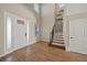 Spacious entryway featuring hardwood floors and a grand staircase at 9511 Tequila Sunrise Dr, Sarasota, FL 34241