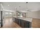 Kitchen boasts an island with quartz countertops and dark cabinetry at 9511 Tequila Sunrise Dr, Sarasota, FL 34241