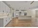 Modern kitchen with white cabinets and a large island at 9511 Tequila Sunrise Dr, Sarasota, FL 34241