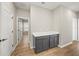 Laundry room with gray cabinets and wood flooring at 9511 Tequila Sunrise Dr, Sarasota, FL 34241
