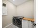 Laundry room with washer, dryer, and patterned tile floor at 9511 Tequila Sunrise Dr, Sarasota, FL 34241