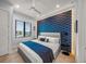 Modern bedroom with geometric accent wall and comfy bed at 101 7Th S St, Bradenton Beach, FL 34217