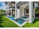 Luxury pool and spa with outdoor kitchen and putting green at 101 7Th S St, Bradenton Beach, FL 34217