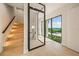 Elegant staircase with glass-paneled doors leading to ocean views at 101 7Th S St, Bradenton Beach, FL 34217