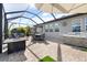 Covered patio with outdoor kitchen, fire pit, and dining area at 1021 Fernleaf Run, Bradenton, FL 34212
