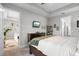 Bright bedroom with a large bed and access to another room at 1021 Fernleaf Run, Bradenton, FL 34212
