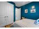Teal bedroom with double doors and unique wall art at 1021 Fernleaf Run, Bradenton, FL 34212