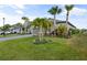 Landscaped yard with palm trees and driveway at 1021 Fernleaf Run, Bradenton, FL 34212