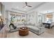 Open concept living room and dining area with large windows at 1021 Fernleaf Run, Bradenton, FL 34212
