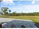 Relaxing patio overlooking a grassy area and river at 1021 Fernleaf Run, Bradenton, FL 34212