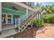 Wooden staircase leading to a partially covered patio at 1110 12Th W St, Bradenton, FL 34205