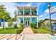 Charming two-story light teal home with a balcony and landscaped yard at 1110 12Th W St, Bradenton, FL 34205