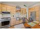 Modern kitchen featuring stainless steel appliances and light wood cabinets at 1110 12Th W St, Bradenton, FL 34205