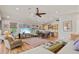 Open living and dining area with hardwood floors, vaulted ceilings and large TV at 1110 12Th W St, Bradenton, FL 34205