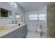 Clean bathroom with a walk-in shower and double vanity at 1213 5Th W St, Palmetto, FL 34221