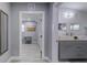 Modern bathroom with double vanity and a view into an adjacent home office at 1213 5Th W St, Palmetto, FL 34221