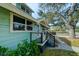 Side view of the house showcasing the porch and landscaping at 1213 5Th W St, Palmetto, FL 34221