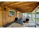Screened porch with wooden ceiling, seating, and ceiling fans at 1213 5Th W St, Palmetto, FL 34221