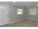 Bright living room with light gray walls, wood-look flooring, and a ceiling fan at 1323 36Th W St, Bradenton, FL 34205