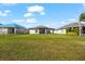 Spacious backyard with grassy lawn and screened patio at 13330 Palmera Vista Dr, Riverview, FL 33579