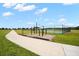 Community recreation area with fitness equipment, sports court, and walking path at 13330 Palmera Vista Dr, Riverview, FL 33579