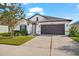 Single-story home with a 2-car garage, landscaping, and walkway at 13330 Palmera Vista Dr, Riverview, FL 33579