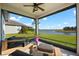 Screened patio with lake view and seating at 13330 Palmera Vista Dr, Riverview, FL 33579