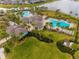 Resort-style community pool and clubhouse with lush landscaping at 14350 Easy Goer St, Ruskin, FL 33573