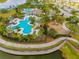 Community pool, playground, and walking paths near a lake at 14350 Easy Goer St, Ruskin, FL 33573