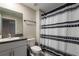 Clean bathroom with shower/tub combo and patterned curtain at 14350 Easy Goer St, Ruskin, FL 33573