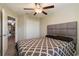 Bedroom with queen bed, ceiling fan, and access to another room at 14350 Easy Goer St, Ruskin, FL 33573