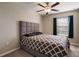 Spacious bedroom with a queen bed and ceiling fan at 14350 Easy Goer St, Ruskin, FL 33573