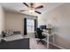 Bedroom with workspace setup and window with blinds at 14350 Easy Goer St, Ruskin, FL 33573