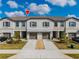 Modern townhome exterior with two-car garage and landscaping at 14350 Easy Goer St, Ruskin, FL 33573