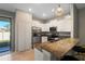 Modern kitchen with white cabinets, granite countertops, and stainless steel appliances at 14350 Easy Goer St, Ruskin, FL 33573