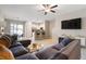 Spacious living room featuring comfortable sectional sofa and open kitchen view at 14350 Easy Goer St, Ruskin, FL 33573