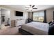 Spacious main bedroom with ensuite bathroom access, large TV, and relaxing seating area at 14350 Easy Goer St, Ruskin, FL 33573
